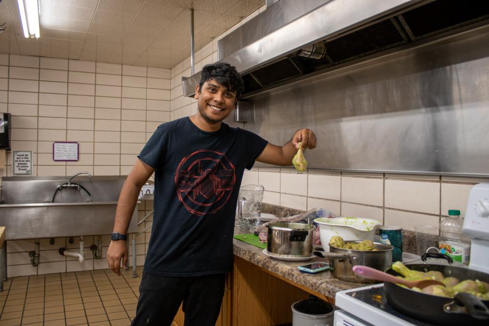 Abhishek Shekhar'24 helps out in the 609 kitchen on symposium day.